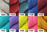 Collection of yarn skeins in various colors with labels.