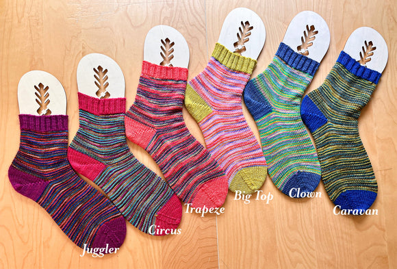 Colorful socks with labels on a wooden surface