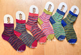 Colorful socks with labels on a wooden surface