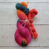 Two skeins of colourful yarn tied together