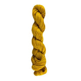 Yellow skein of yarn on a white background