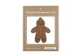 Wooden gingerbread kid shape with holes embroidery thread in paper package