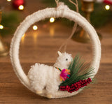 Decorative ring with a small plush duck and festive elements on a dark surface, featuring a 'River of Yarn' tag.