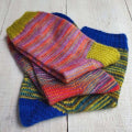 Colorful knitted socks on a wooden surface