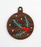 Circular wooden ornament with holes embroidery thread